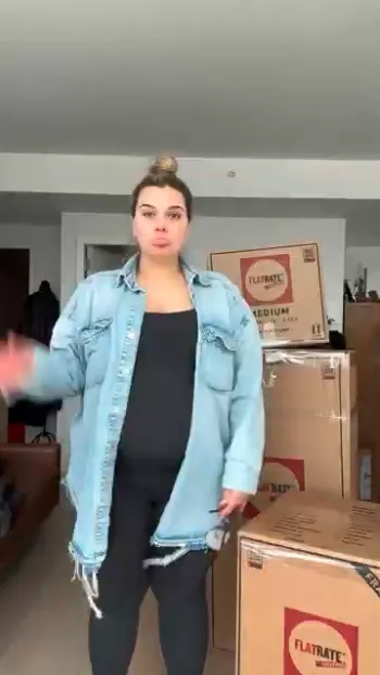 Pregnant lady rounded by moving boxes