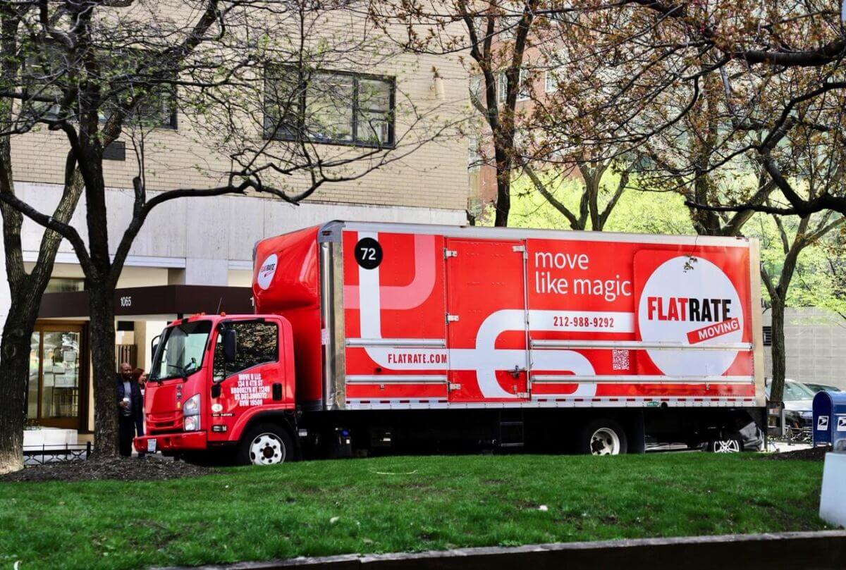 Flatrate truck parked outside a building